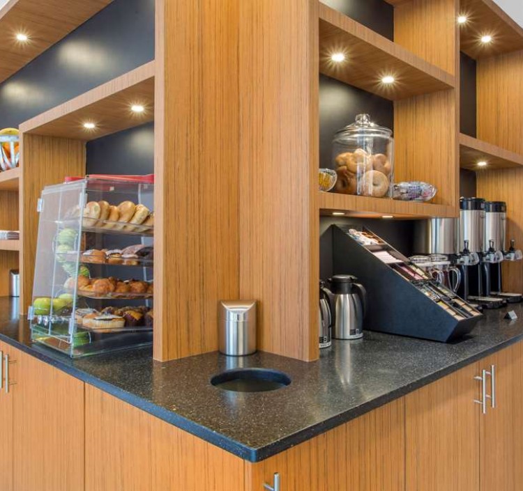 Breakfast counter with bakery items, fruit, and coffee