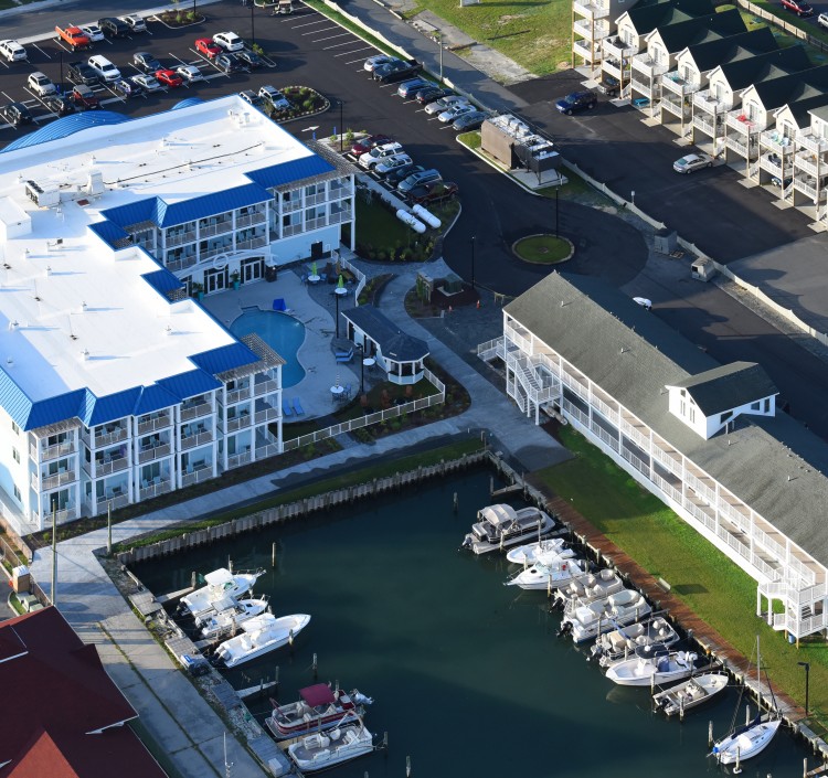 aerial image of hotel, pool and marina with docked boats