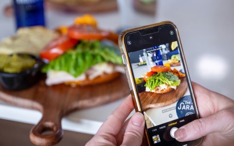 a person taking a picture of food