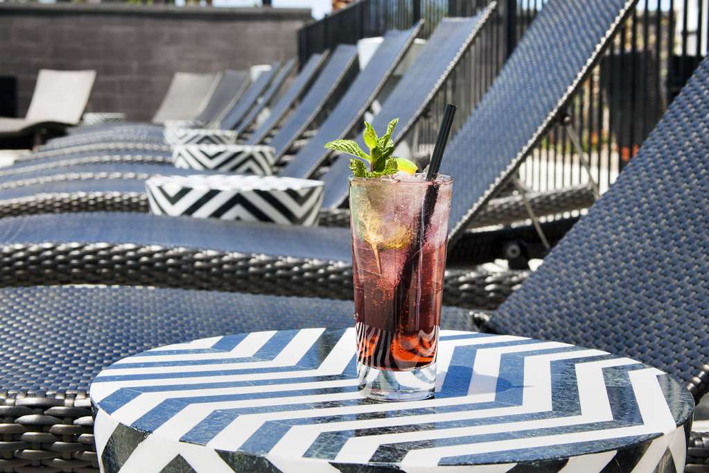 cocktail on side table next to sundeck lounge chair