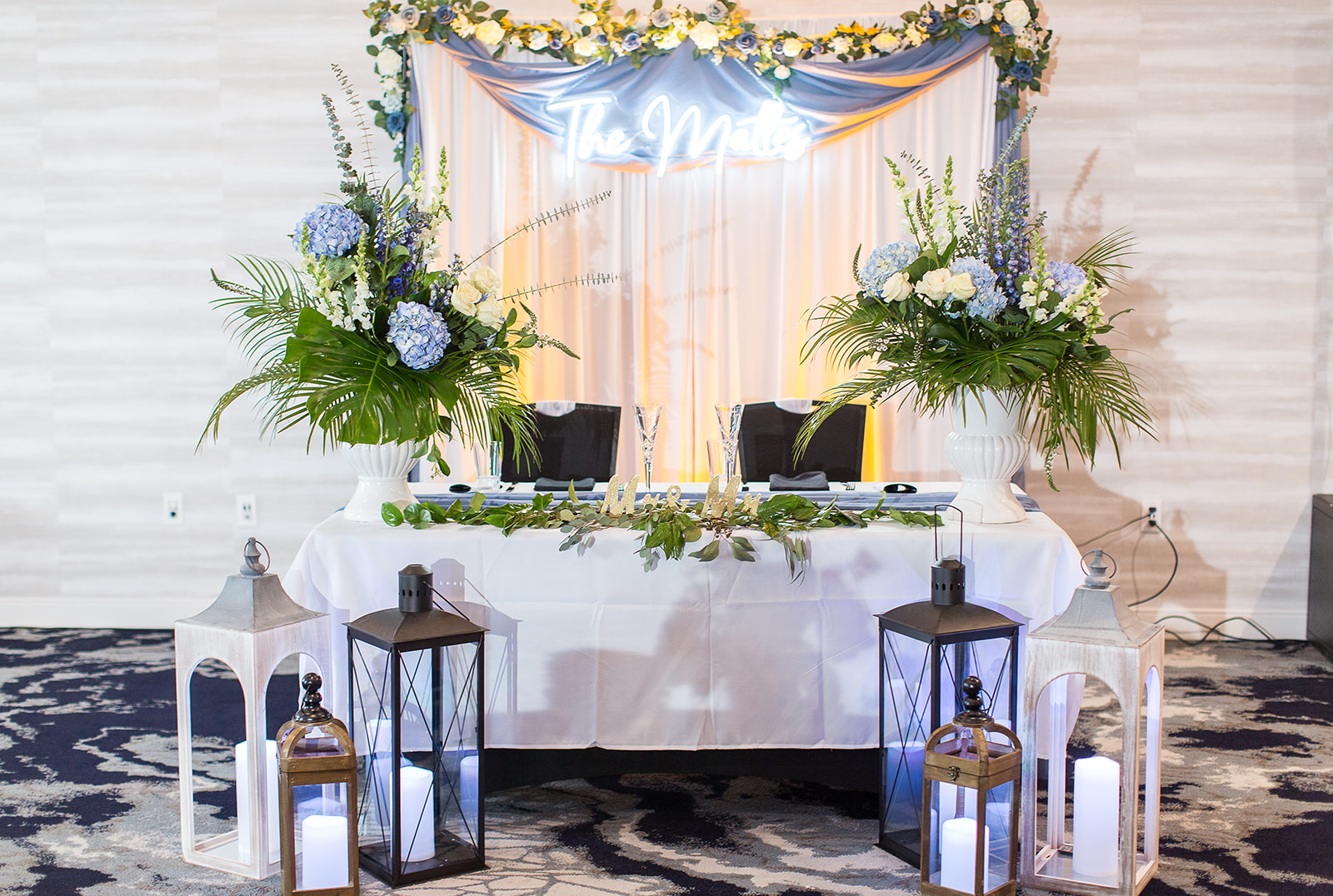 a table with flowers and lanterns