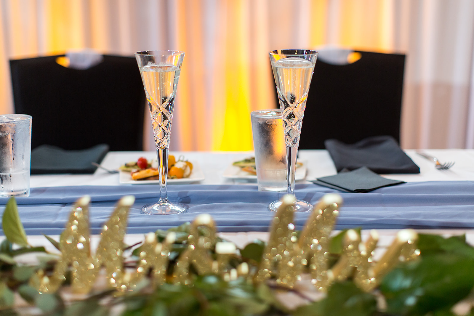 two glasses of champagne on a table