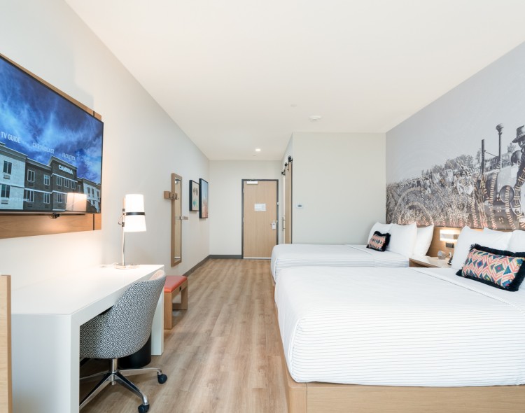a room with two beds and a desk