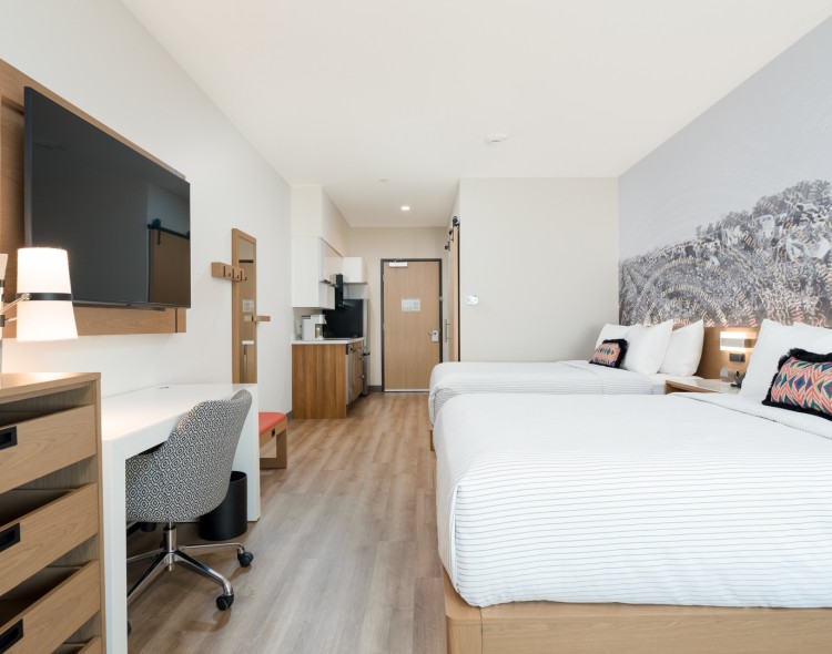 a room with two beds and a tv