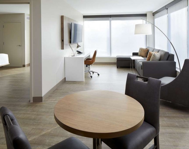 suite with living room and breakfast table seating