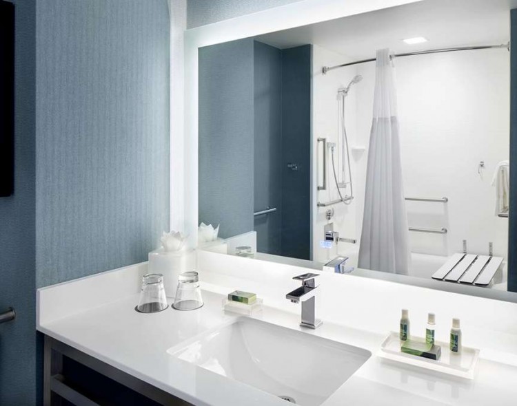 guest bathroom with lighted vanity mirror