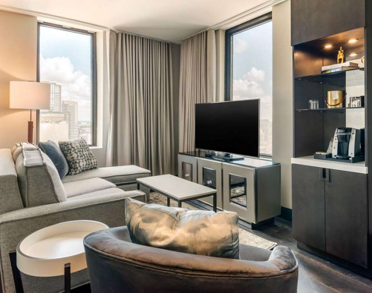 living room area in suite with couch and tv