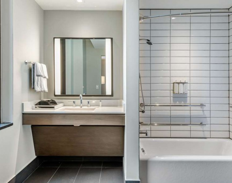 Bathroom in guest room with grab bars in tub