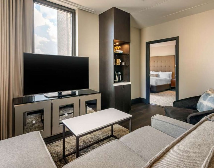 living room area in suite with couch and tv