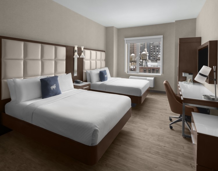 a room with two beds and a desk