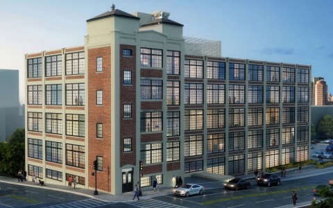 a building with many windows and cars on the street