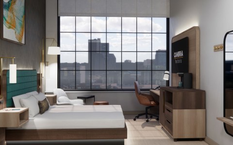 a bedroom with a large window and a bed
