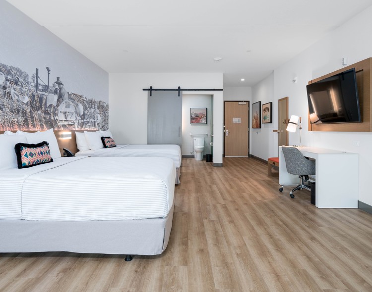 a room with two beds and a tv