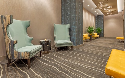 a room with chairs and a lamp