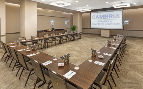 a room with long tables and chairs