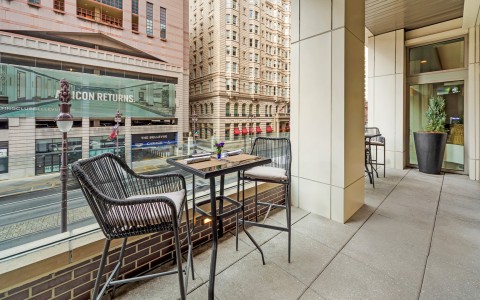 a table and chairs outside a building