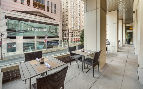 a patio with tables and chairs