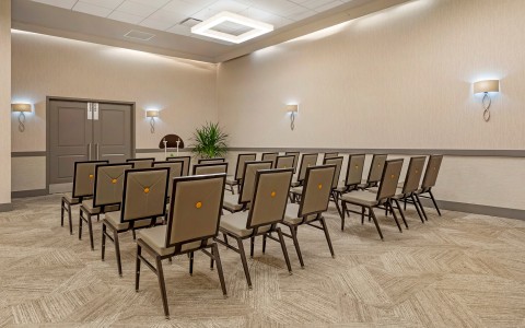 a room with chairs and a door