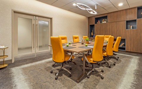 a conference room with a table and chairs