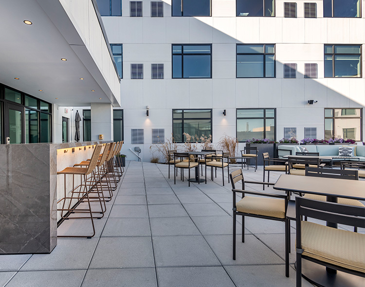 A rooftop with tables and chairs