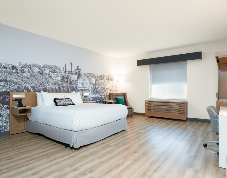 a room with a bed and a wood floor