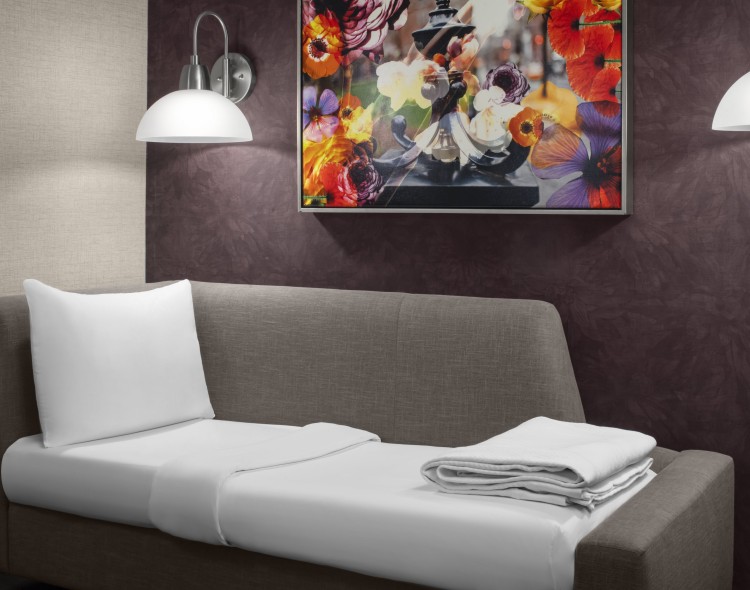 a couch with a picture on the wall