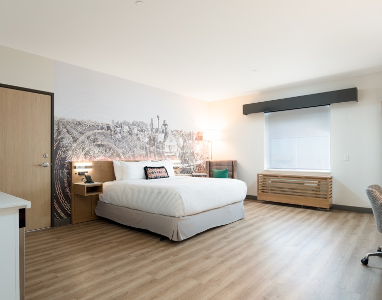 a room with a bed and a wood floor