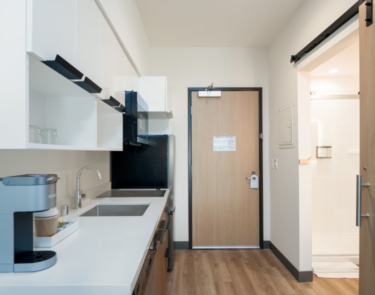 a kitchen with a door and a wood floor