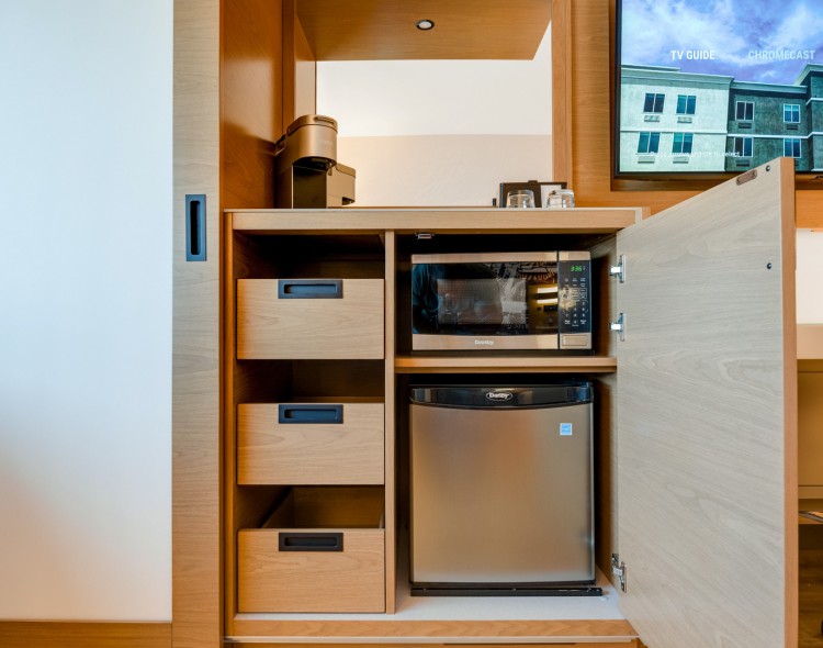 a small kitchen with a microwave and a refrigerator
