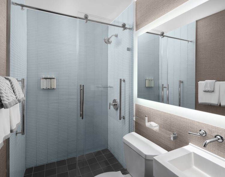 a bathroom with a glass shower and a toilet