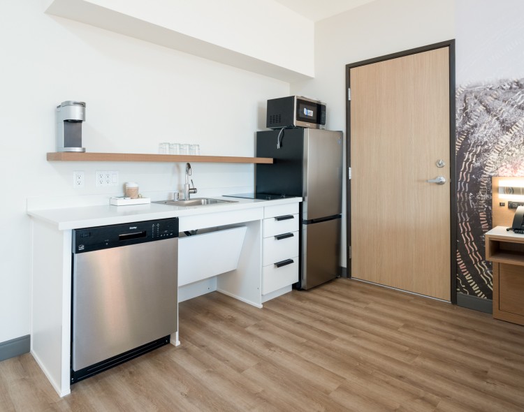 a kitchen with a wood floor and a wood floor