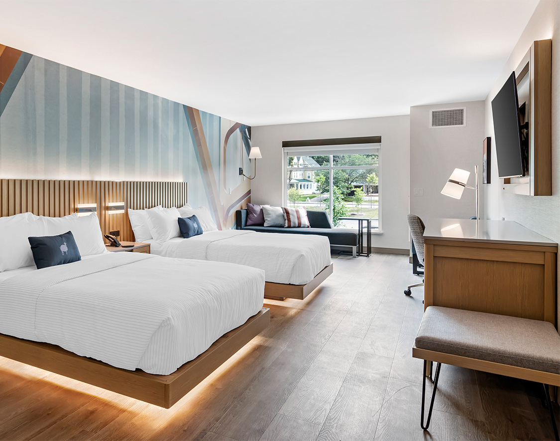 a room with two beds and a tv