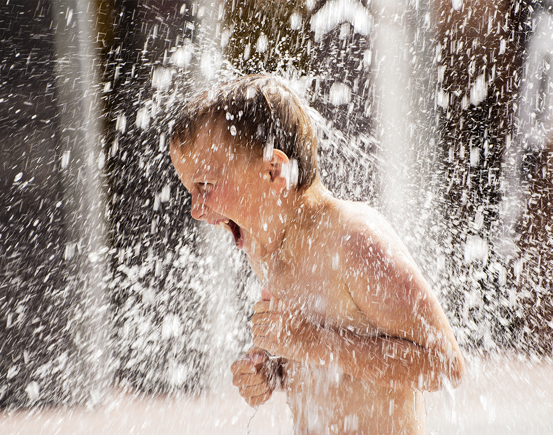 a boy in a water spout