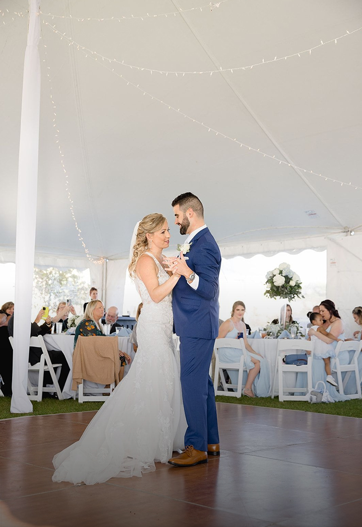 a man and woman dancing under a tent