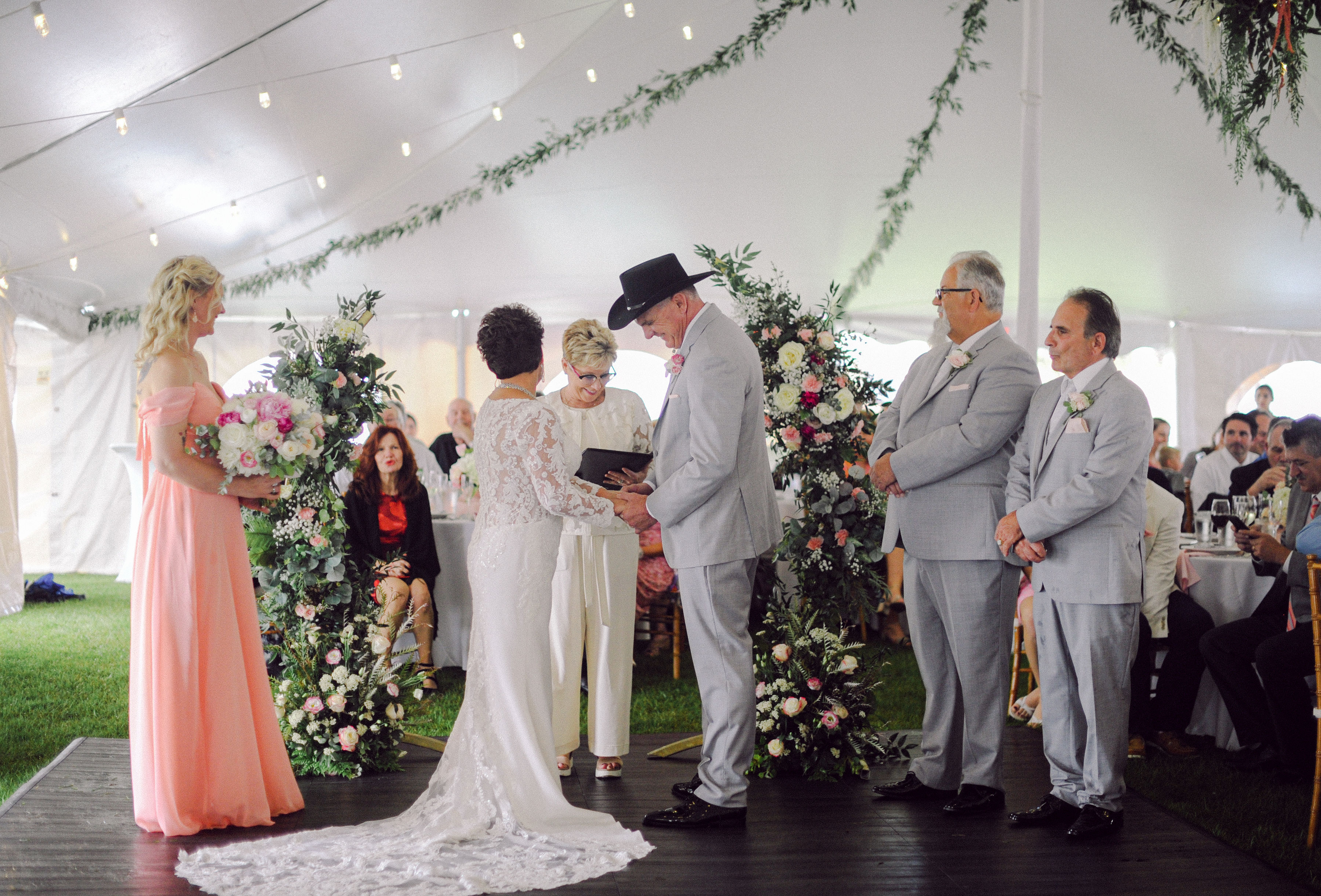 a group of people standing under a tent