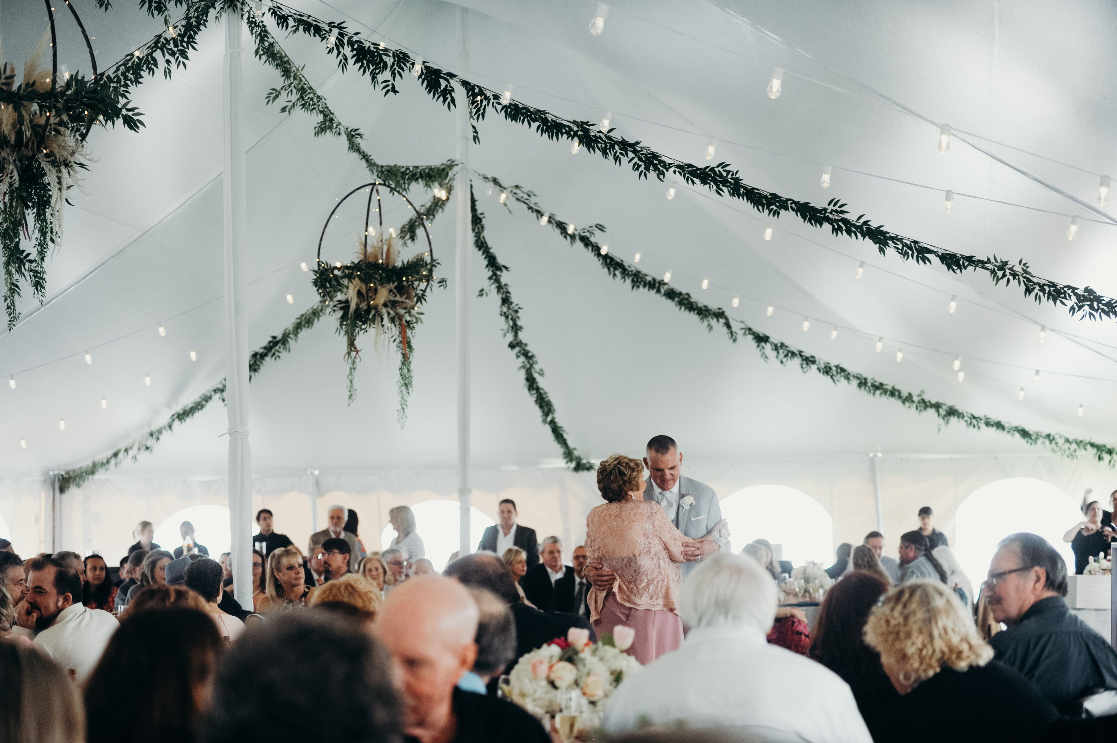 a man and woman dancing in a tent