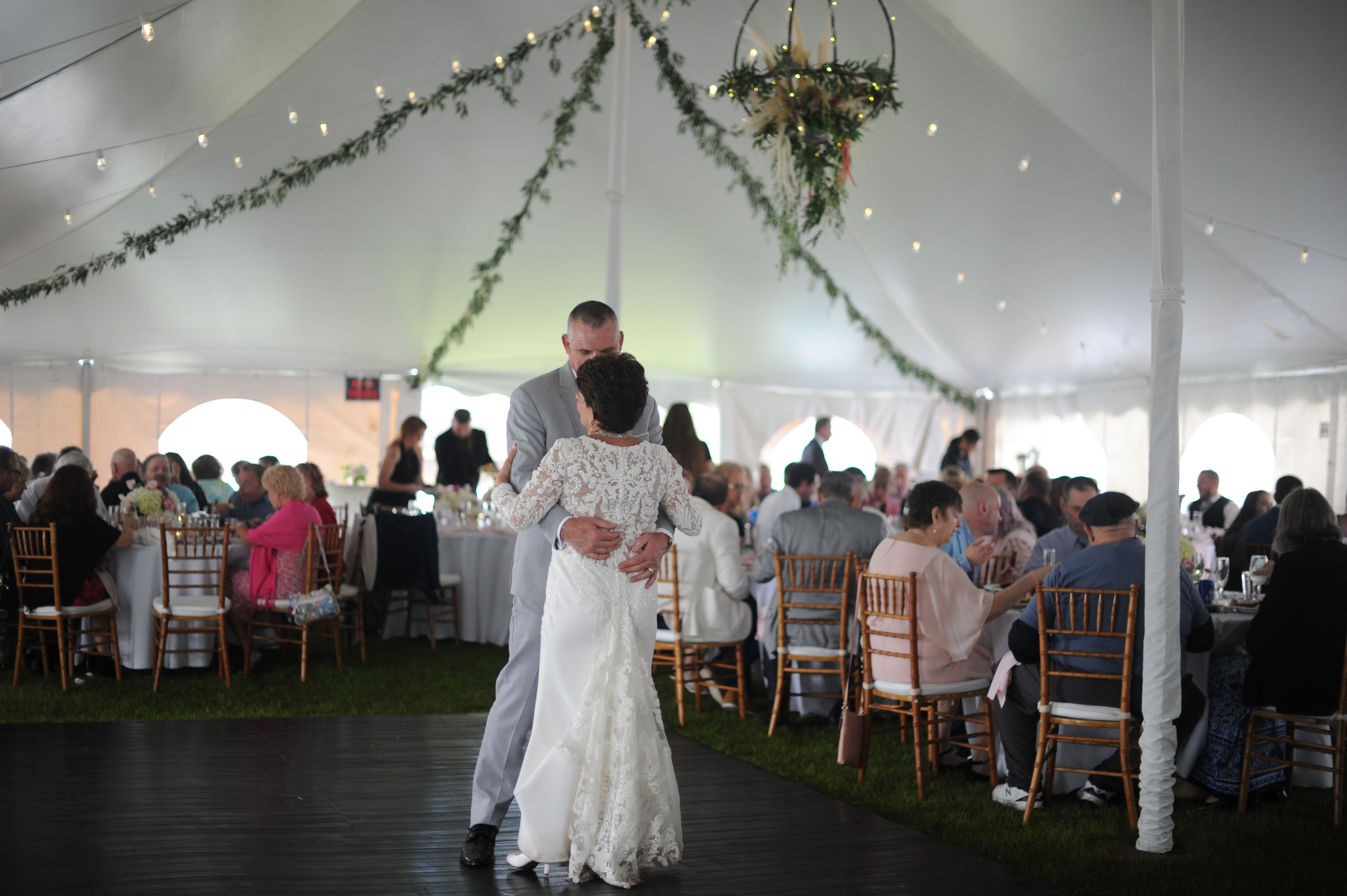 a man and woman dancing in a tent