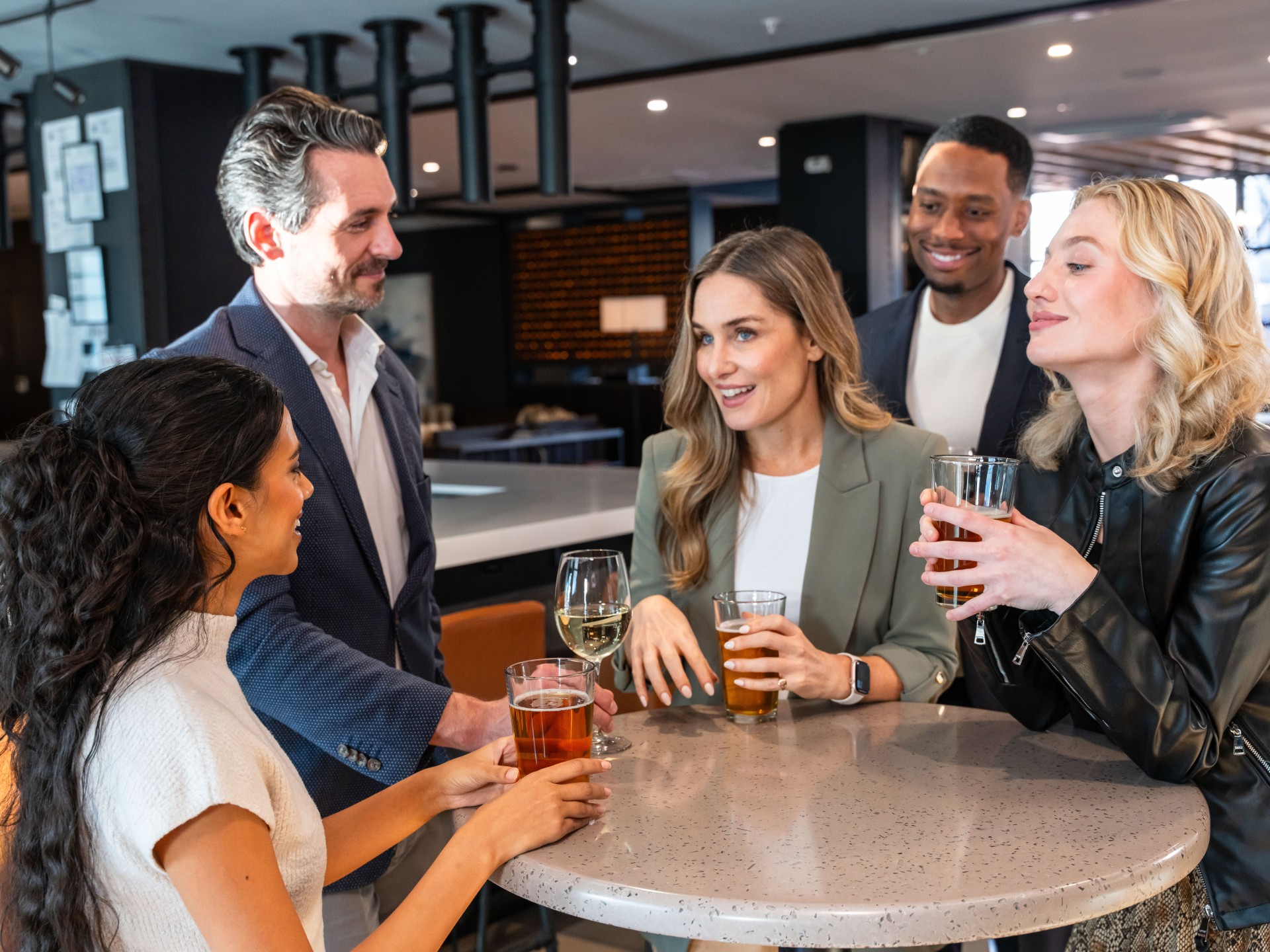 a group of people sitting around a table with drinks