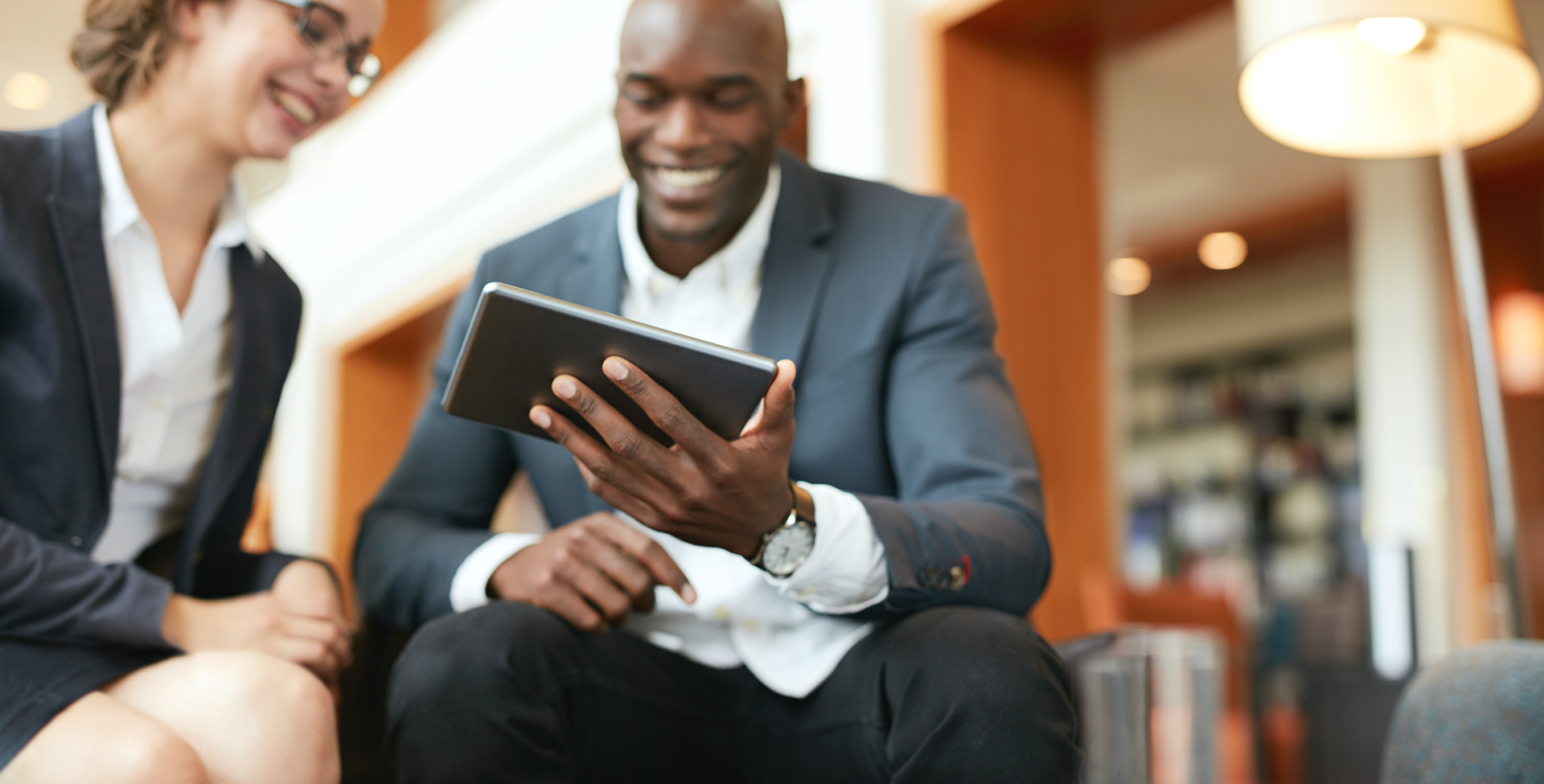 man in a suit on his tablet