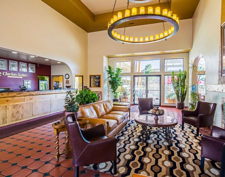 hotel lobby with seating area and a round chandelier