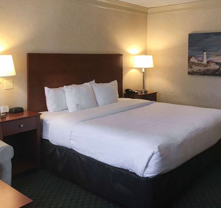 bed and seating area with table in guest room