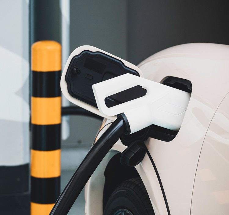 a white car with a black and yellow pole