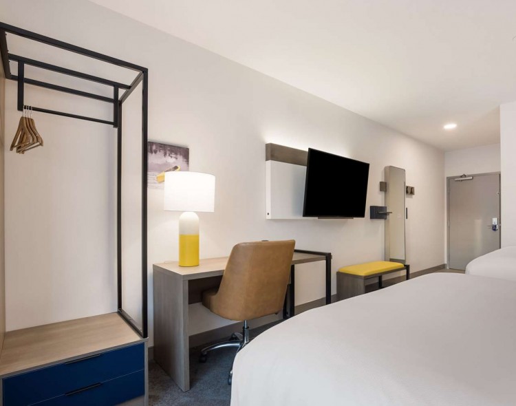 hanging space in room next to a desk and mounted tv