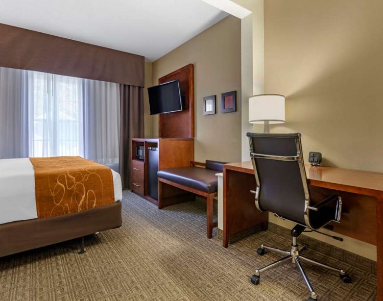 a spacious suite with desk and living room area