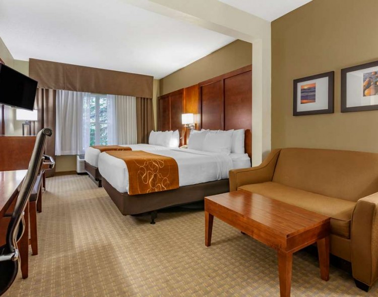 guest suite with two double beds and a sitting area