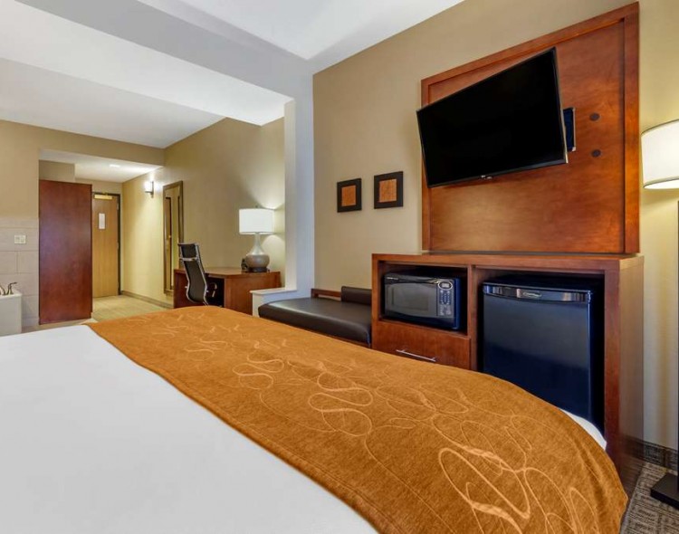 a guest suite with a king bed and a separate living space