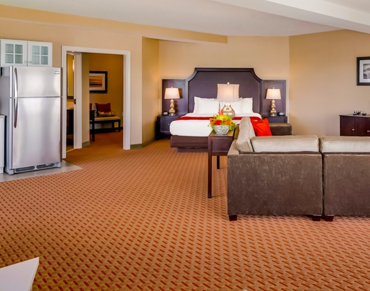 indoor view of a bedroom suite and a kitchen