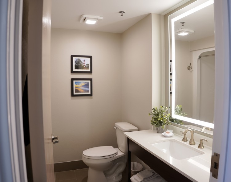 entrance of a bathroom with a toilet and sink