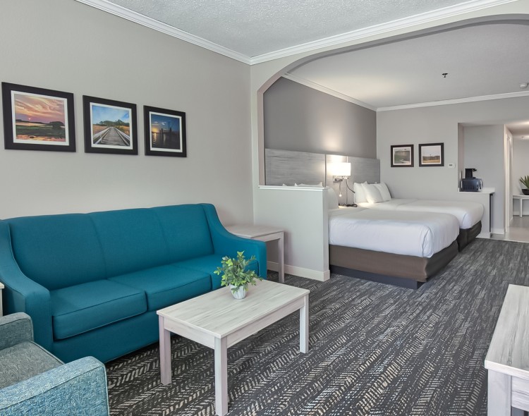 two queen bedroom suite of the hotel with a living room and small kitchen