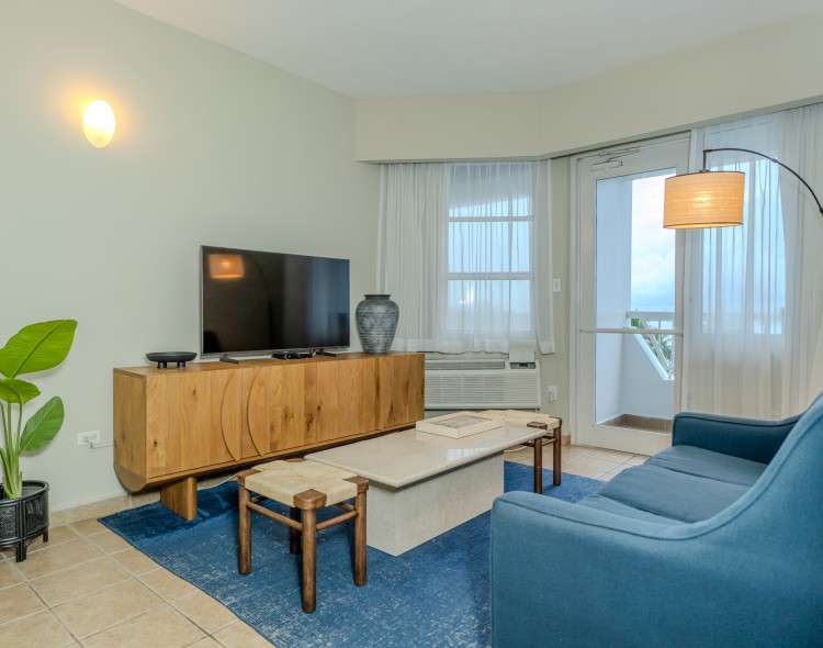 a living room with a television and a table
